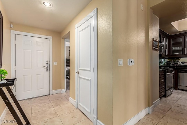 hallway featuring light tile patterned floors