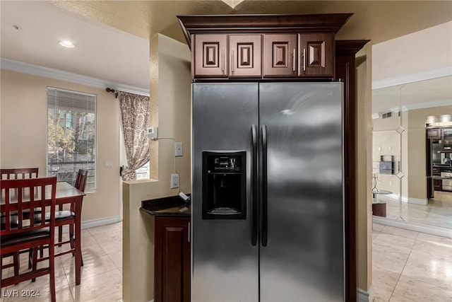 kitchen with crown molding, light tile patterned floors, and stainless steel refrigerator with ice dispenser