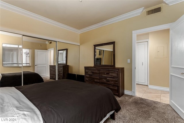 bedroom with light carpet, a closet, and crown molding