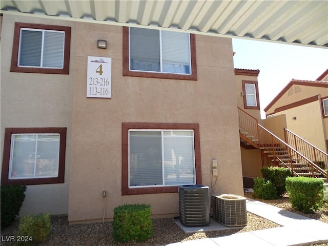 rear view of house featuring cooling unit