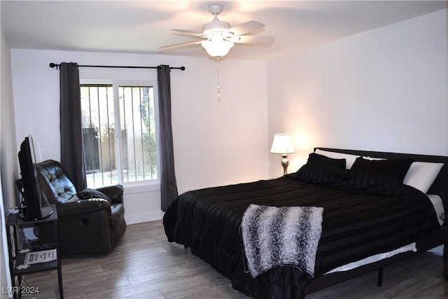 bedroom with hardwood / wood-style floors and ceiling fan