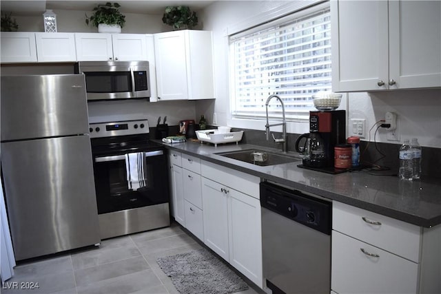 kitchen with white cabinetry, sink, and stainless steel appliances