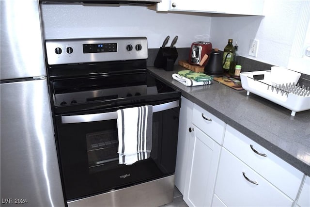 kitchen with white cabinets and appliances with stainless steel finishes