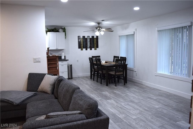 dining space featuring wood-type flooring and ceiling fan