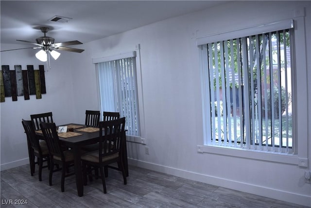 dining space with dark hardwood / wood-style floors and ceiling fan