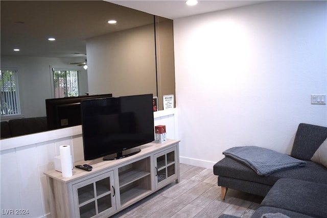 living room with ceiling fan and light hardwood / wood-style floors