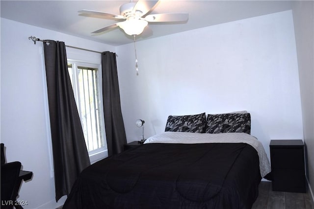 bedroom featuring ceiling fan and dark hardwood / wood-style flooring