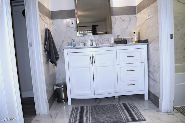 bathroom with vanity and tile walls