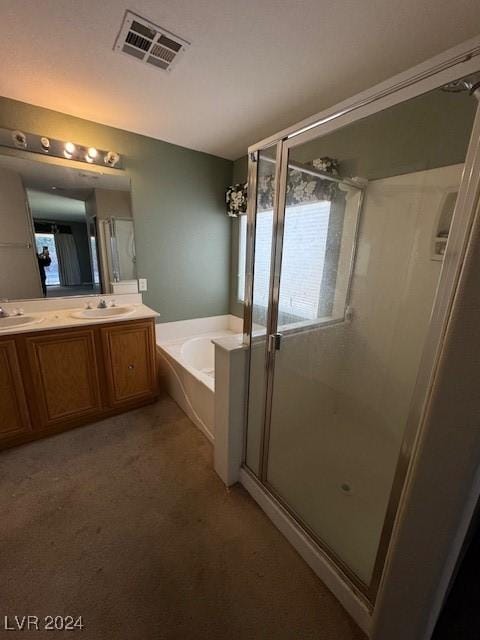 bathroom featuring vanity and independent shower and bath