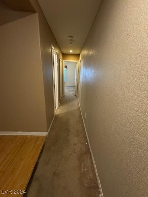 hallway with hardwood / wood-style floors