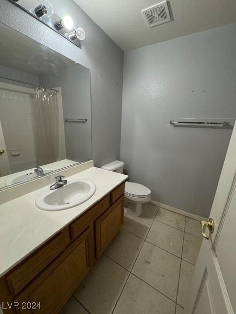 bathroom with tile patterned flooring, vanity, toilet, and a shower with curtain