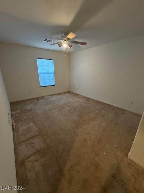 empty room with ceiling fan and carpet floors