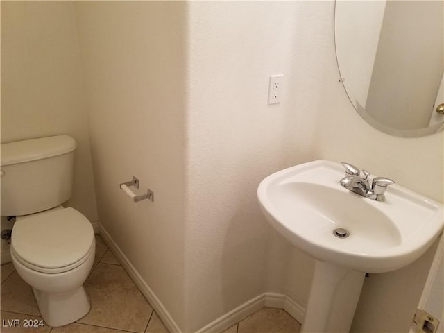 bathroom featuring tile patterned flooring and toilet