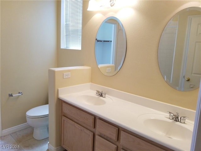 bathroom featuring tile patterned flooring, vanity, and toilet