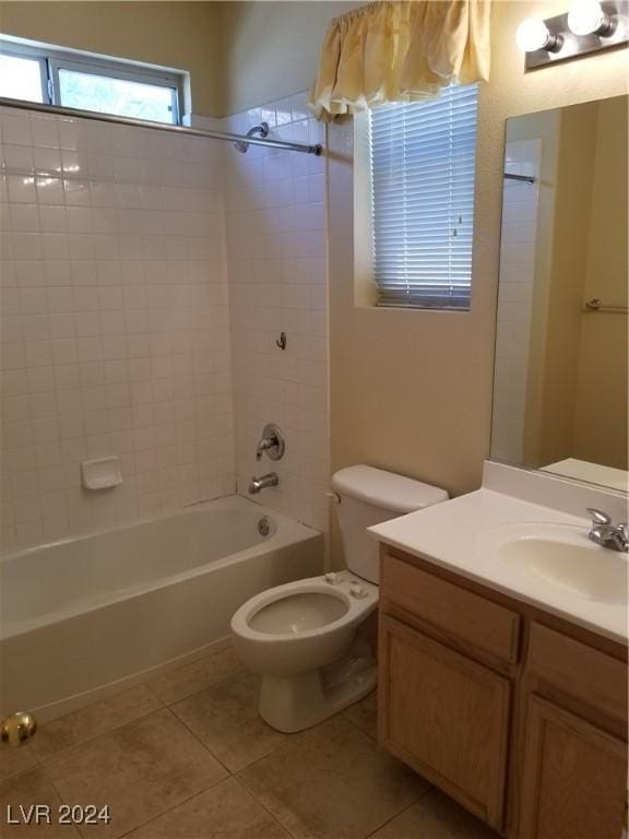 full bathroom with toilet, vanity, tiled shower / bath combo, and tile patterned floors