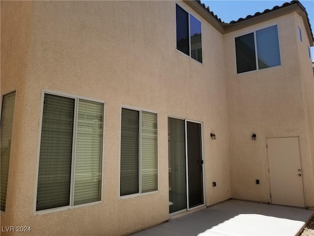 back of house with a patio