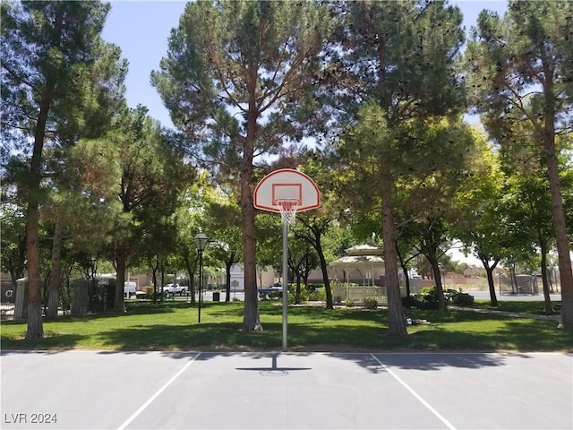 view of basketball court featuring a lawn