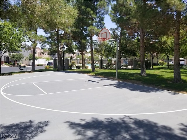 view of basketball court featuring a yard