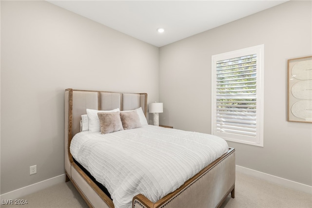 bedroom featuring light colored carpet