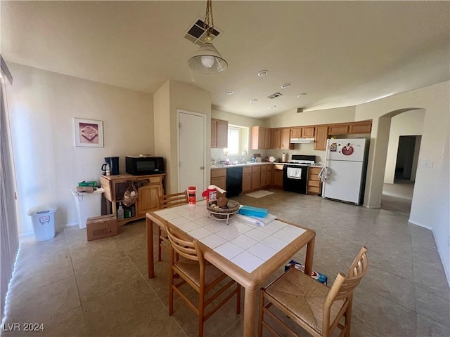 tiled dining area featuring lofted ceiling