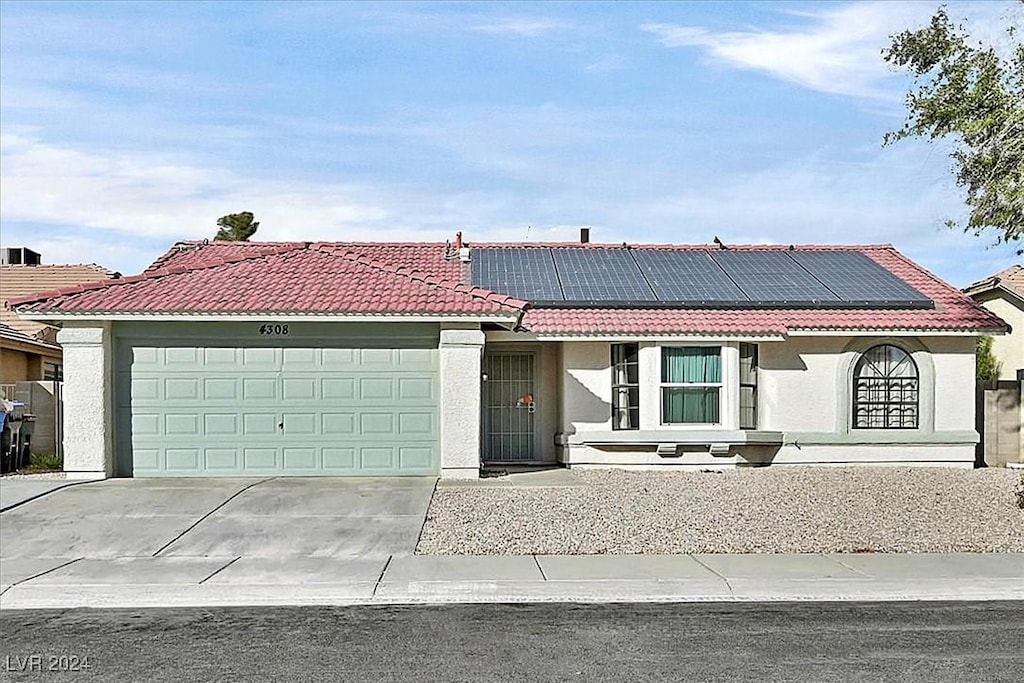 view of front of house with solar panels and a garage