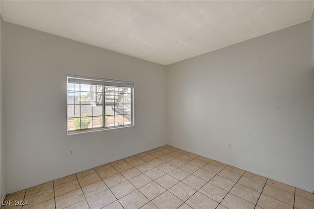 unfurnished room featuring light tile patterned floors