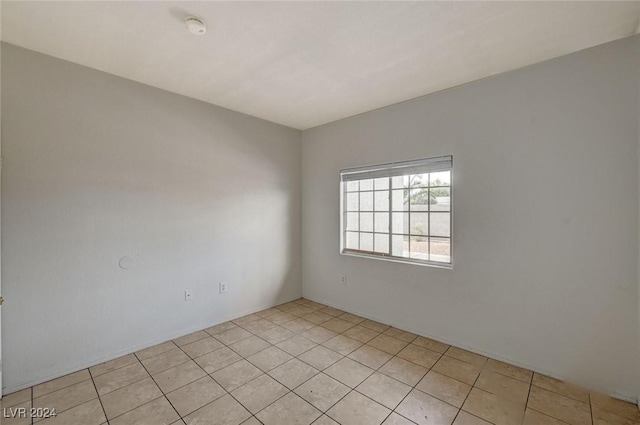 unfurnished room with light tile patterned flooring