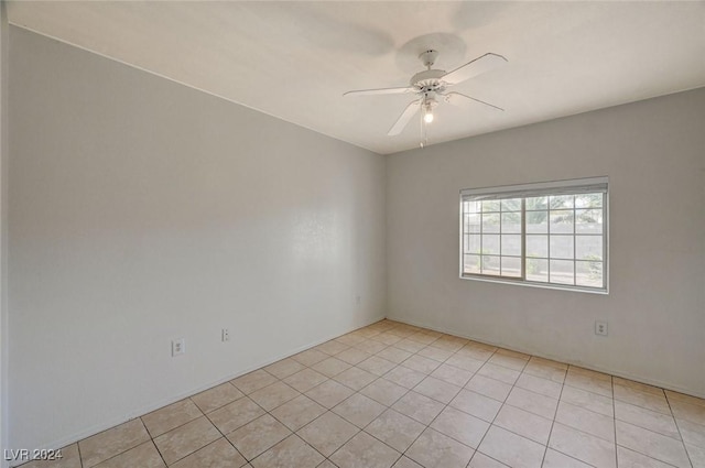 unfurnished room featuring ceiling fan and light tile patterned floors