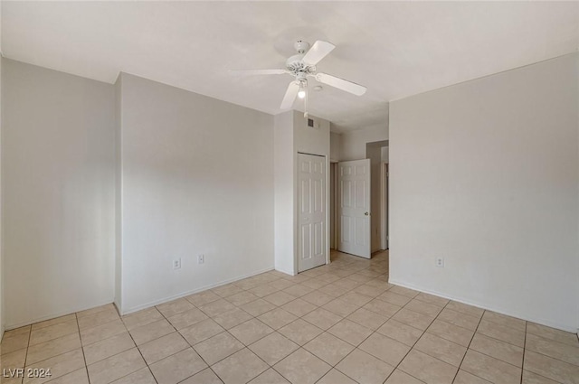 spare room featuring ceiling fan and light tile patterned floors