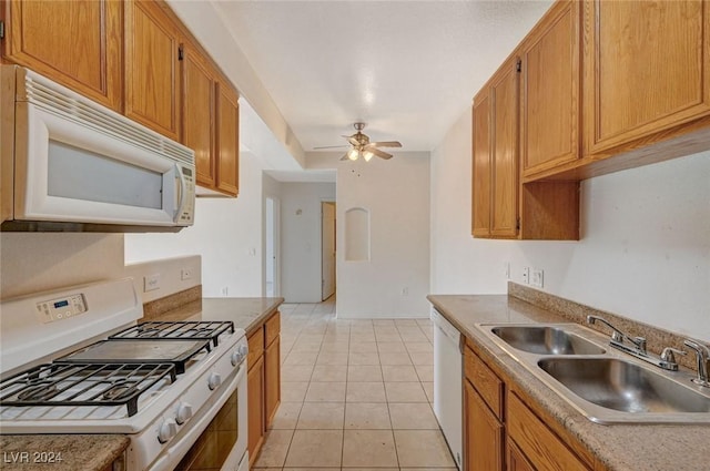 kitchen featuring light tile patterned floors, white appliances, ceiling fan, and sink