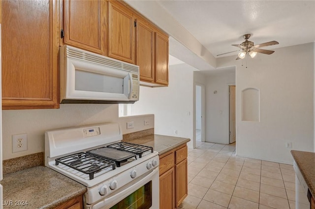 kitchen featuring ceiling fan, white appliances, and light tile patterned floors