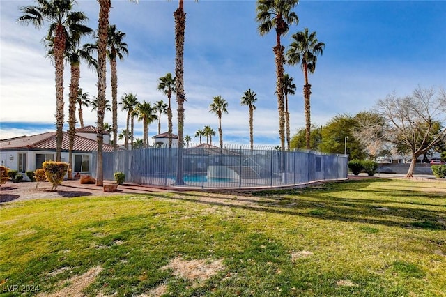 view of pool featuring a lawn