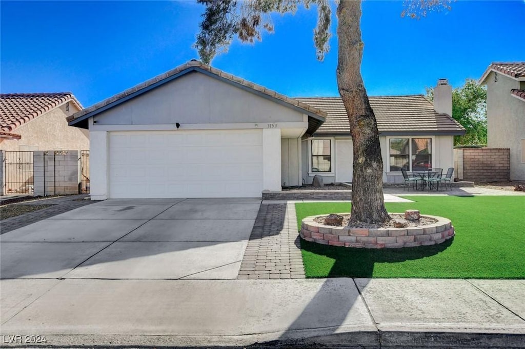 single story home with a front yard and a garage