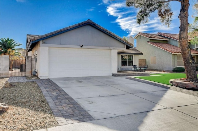 view of front of property with a garage and a patio