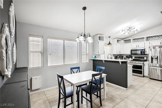 dining room with a notable chandelier, lofted ceiling, sink, and light tile patterned floors