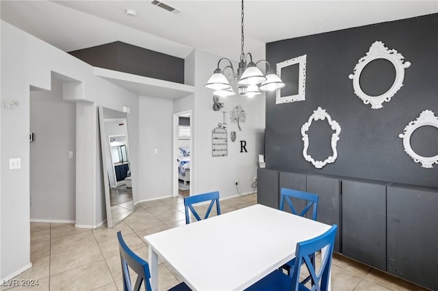 tiled dining space featuring a chandelier