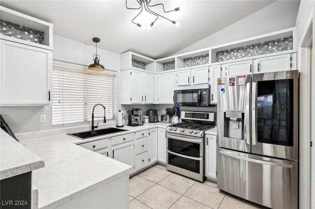 kitchen with white cabinets, hanging light fixtures, vaulted ceiling, light tile patterned floors, and appliances with stainless steel finishes