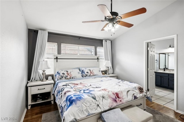 bedroom featuring lofted ceiling, ceiling fan, ensuite bathroom, and dark hardwood / wood-style floors