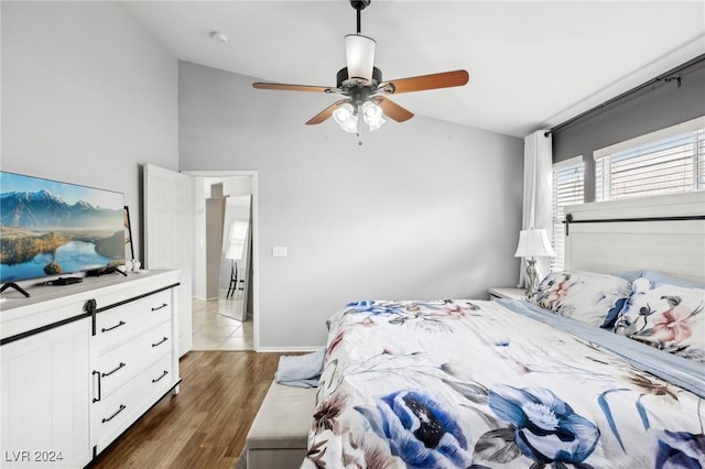 bedroom with lofted ceiling, ceiling fan, and dark hardwood / wood-style floors