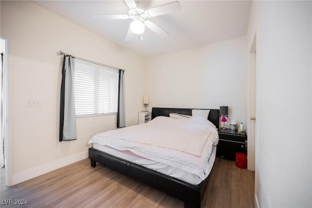 bedroom with light wood-type flooring and ceiling fan