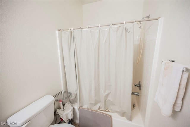 bathroom with shower / bath combo with shower curtain and toilet