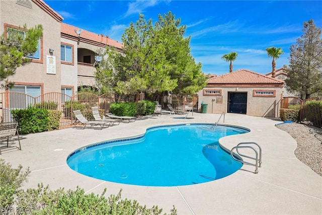 view of pool featuring a patio area and an outbuilding