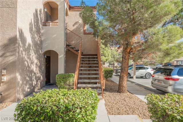 view of side of home featuring a balcony