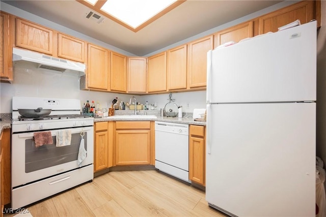 kitchen featuring light stone countertops, white appliances, sink, light brown cabinets, and light hardwood / wood-style floors