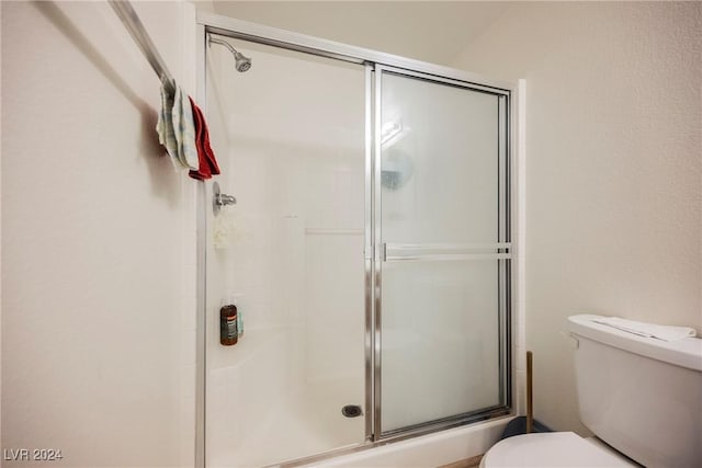 bathroom with toilet and walk in shower