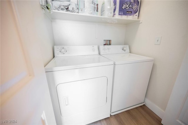 laundry area featuring washer and dryer and light wood-type flooring