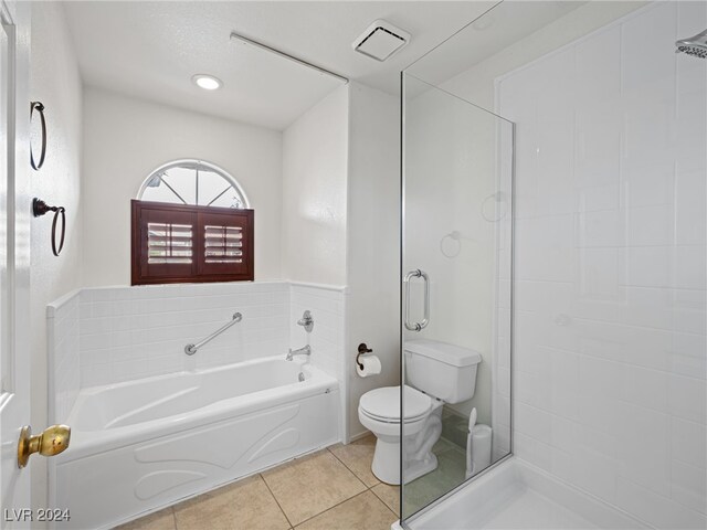 bathroom with tile patterned floors, separate shower and tub, and toilet