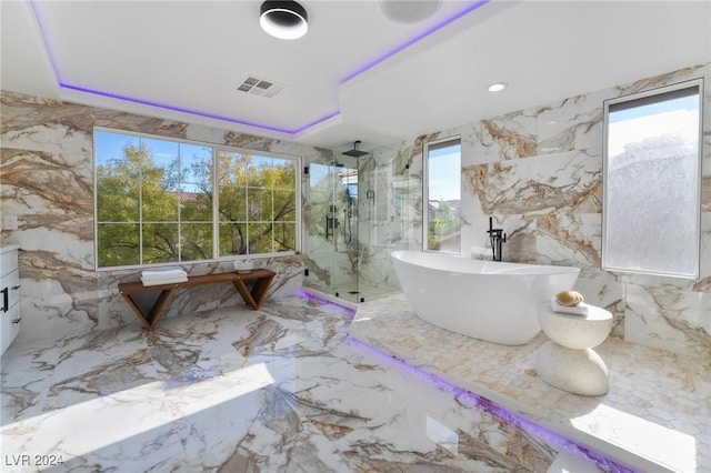 bathroom featuring vanity, tile walls, and independent shower and bath