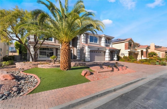 view of front of home with a front yard and a garage