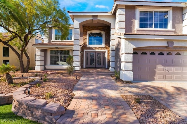 entrance to property featuring french doors and a garage